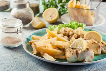 Steamed cod fish with french fries and boiled cauliflower