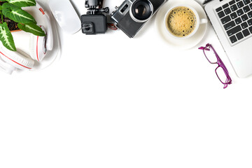 top view of office desk table with coffee cup, laptop, action camera and vintage camera