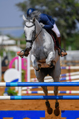 Rider jumps over obstacles during horse show jumping