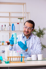 Young male chemist working in the lab