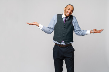 Doubt concept - Young african american businessman wearing tie and over light grey background clueless and confused expression with arms and hands raised