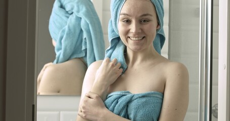 Beautiful woman after bath or shower smiling to camera