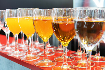 Glasses with juice on the table. Various types of soft drinks. Close-up