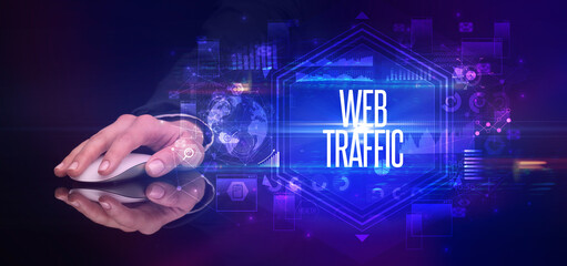hand holding wireless peripheral with WEB TRAFFIC inscription, cyber security concept