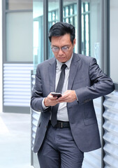 Chinese businessman using his cellphone