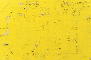 A yellow wall with small cracks. Beautiful retro background for designer