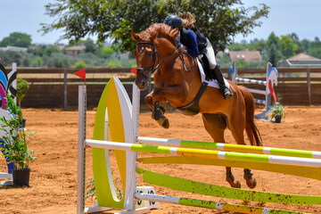 Rider jumps over obstacles during horse show jumping