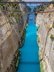 View from the bridge to the boats and yachts passing through the Corinth Canal from a sunny day on...