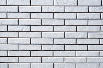 White brick wall background. Textured white clean brick wall, background with copy space. Texture of white wall facade background close up.