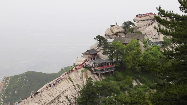 Tourists climbing magnificent Mount Hua or Huashan, a mountain near city of Huayin in Shaanxi, about 120 km east of Xi'an. One of 5 Great Mountains of China with long history of religious significance