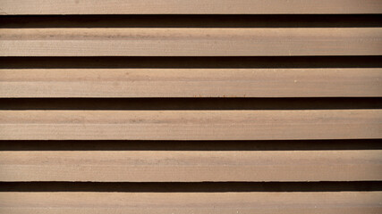 
Half-open wooden shutters, blinds, under the overwhelming light of the summer sun