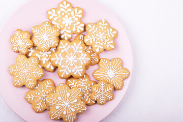 A plate of Christmas cookies with a festive decoration on a white background