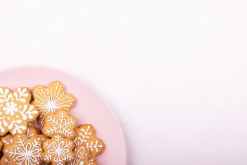 A plate of Christmas cookies with a festive decoration on a white background