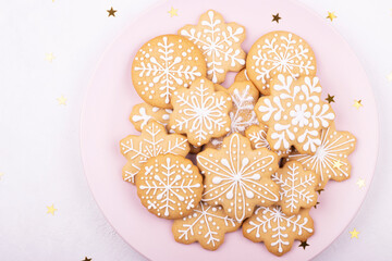 A plate of Christmas cookies with a festive decoration on a white background