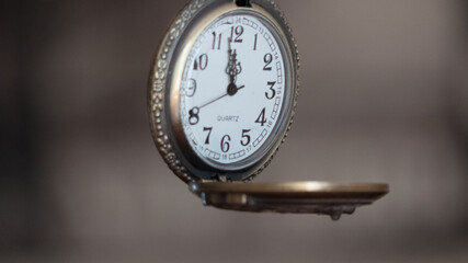 fob watch suspended at 12pm