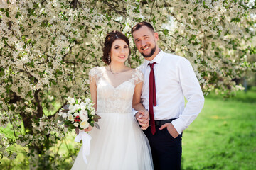 newlyweds in a blooming spring garden