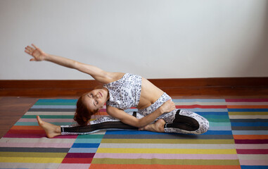 Women practice yoga at home