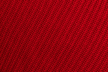 Red knitted woolen fabric background