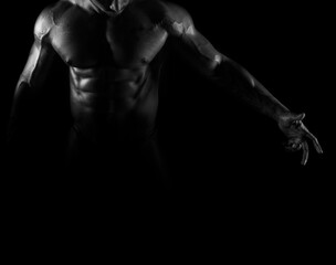Fototapeta na wymiar Silhouette of young athlete bodybuilder man on black