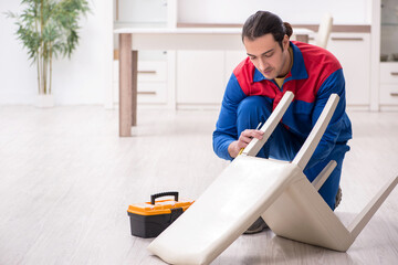 Young male carpenter working indoors