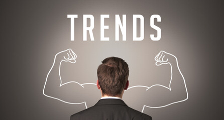 Rear view of a businessman with TRENDS inscription, powerfull business concept