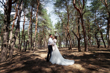 the bride and groom are walking in the woods