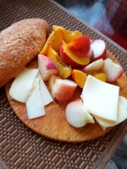 Peach, apricot, cheese and bun. Autumn snack.