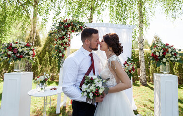 husband and wife near the wedding arch