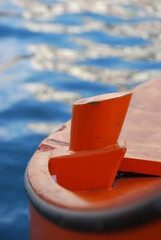 
particular orange wooden boat where the peaks are tied
