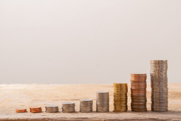 Coin Stack on real wood with soft white color, good for save money background, or business growing