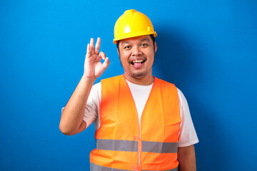 Pleased confident fat asian constructuin worker man with broad smile