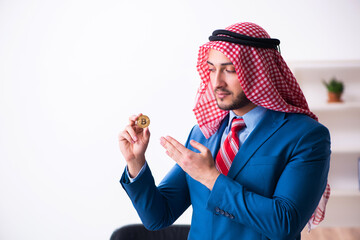Young male arab employee working in office