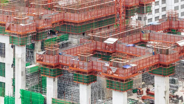 Footage 4k Timelapse, Overhead view of construction workers fabricating steel reinforcement bar on A suspended platform at the skyscraper construction site, The reinforcement bar was tied together.