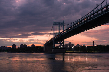 Fototapeta na wymiar Triborough Bridge during a Beautiful Sunset over the East River connecting Astoria Queens New York to Wards and Randall's Island