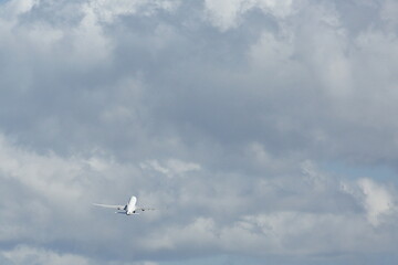 Fototapeta na wymiar an airplane flying in the sky with cloud