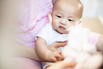 Asian baby happy in the room.Asian baby girl lying down on bed .