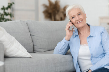 Concierge Services. Smiling Senior Woman Talking On Cellphone With Personal Assistant Manager