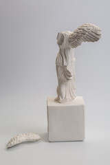 Greek goddess of victory sculpture on white background
