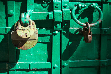 Old metal padlock on a wooden door