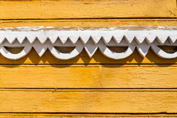 wood carving on yellow walls in Russian style