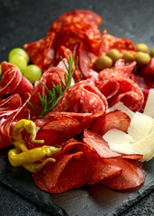 Set of Salami, chorizo, coppa, lomo, beef, Meat antipasto platter on stone board