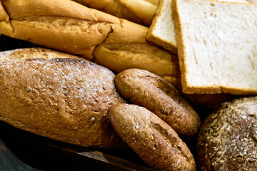 Close up of Assortment of  varities baked brown bread in wooden tray