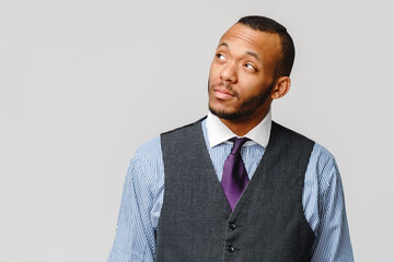 Studio shot of young African-American businessmanman over grey background