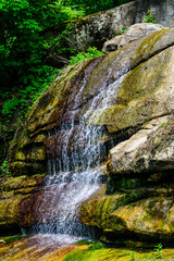 Beautiful waterfall on small river in a park