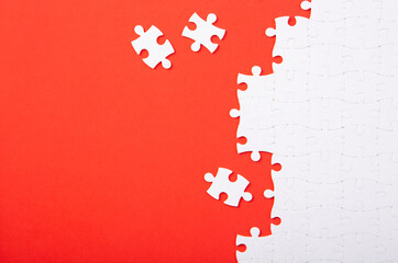 Blank white puzzle pieces on red background, flat lay