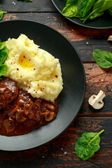 Salisbury Steak with mushroom gravy, mashed potatoes and spinach