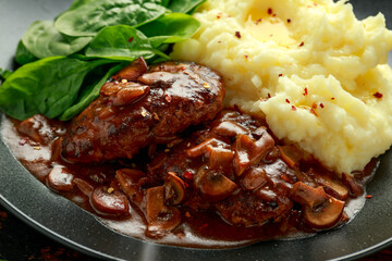 Salisbury Steak with mushroom gravy, mashed potatoes and spinach