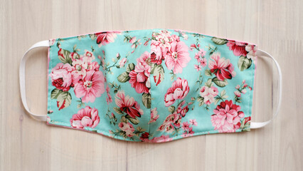 Face mask made out of cotton fabric place on wood texture table