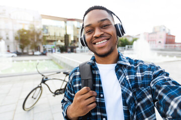 Excited african american guy talking selfie with his bike