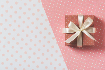 Gift box polka dot pattern on light and pink background